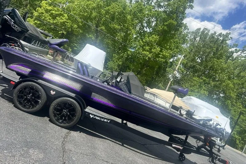 The Image of 2025 Phoenix 919 ZXL boat on trailer, parked outdoors with trees in background. - 1