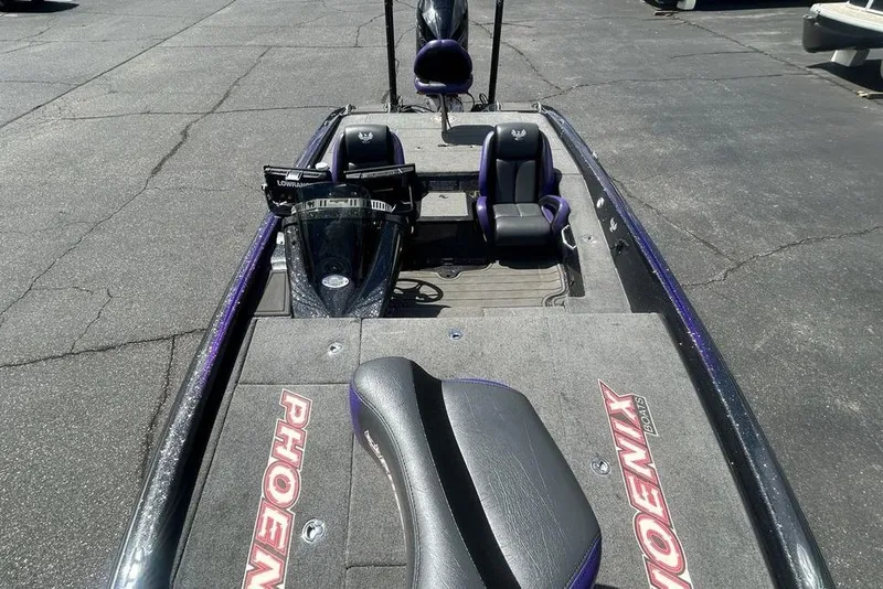 Slide: The Image of 2025 Phoenix 919 ZXL boat with dual seats and sleek design on asphalt surface. - 10