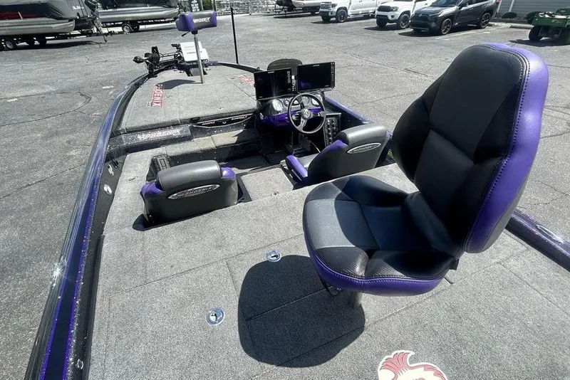 Slide: The Image of 2025 Phoenix 919 ZXL boat interior with purple and black seating, advanced dashboard controls. - 15