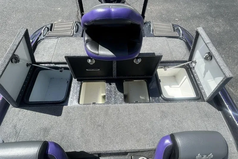 Slide: The Image of 2025 Phoenix 919 ZXL boat interior with open storage compartments and seating. - 16