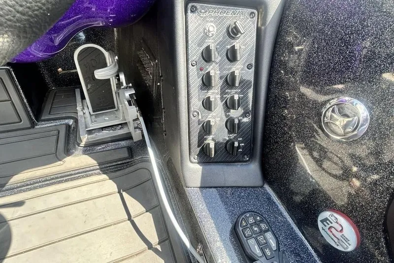 Slide: The Image of Control panel of a 2025 Phoenix 919 ZXL boat with foot pedal and switches. - 18