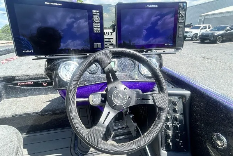 Slide: The Image of Dashboard of a 2025 Phoenix 919 ZXL boat with dual navigation screens. - 20