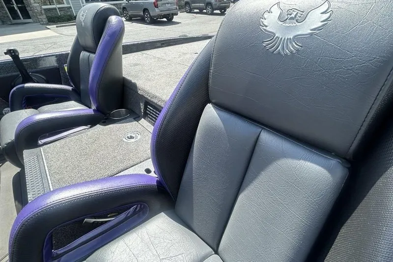 Slide: The Image of Luxurious leather seats in a 2025 Phoenix 919 ZXL boat, featuring purple accents and an eagle emblem. - 22