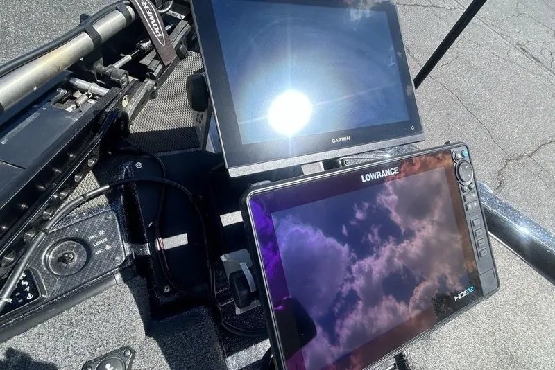 Slide: The Image of Dual marine navigation screens on a 2025 Phoenix 919 ZXL boat dashboard. - 24