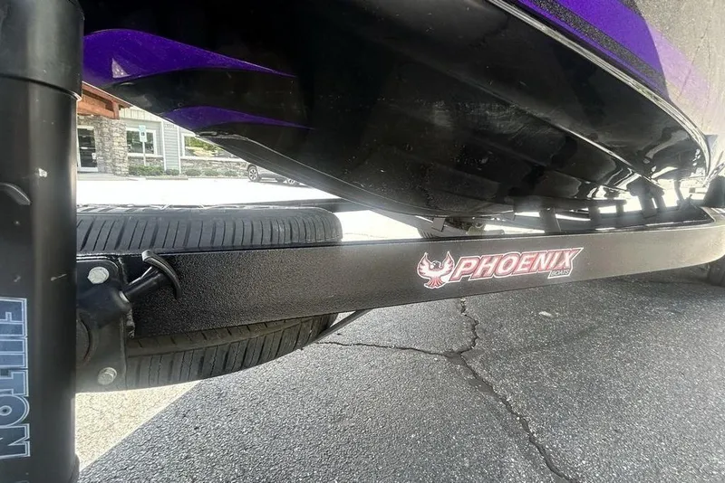 Slide: The Image of Trailer of a 2025 Phoenix 919 ZXL boat with visible tire and branding. - 25