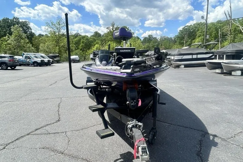 Slide: The Image of 2025 Phoenix 919 ZXL boat in parking lot, surrounded by trees and vehicles. - 6