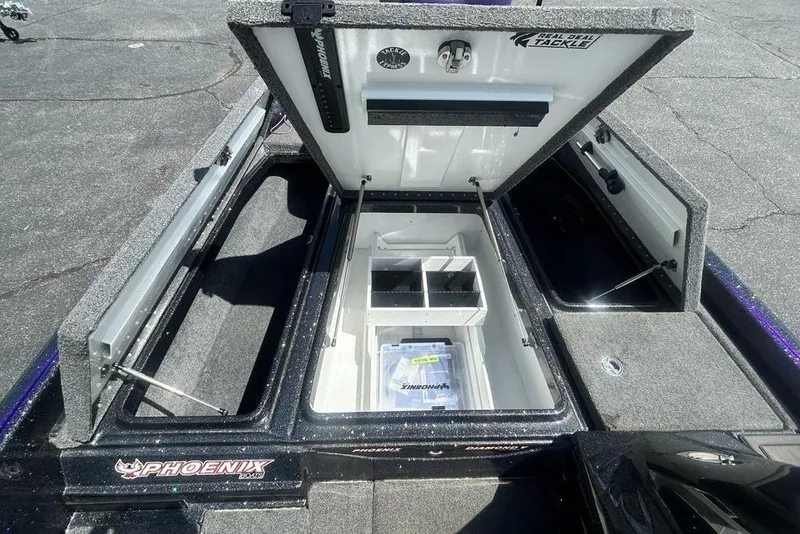Slide: The Image of Open storage compartments of a 2025 Phoenix 919 ZXL boat, showcasing organized tackle boxes. - 7