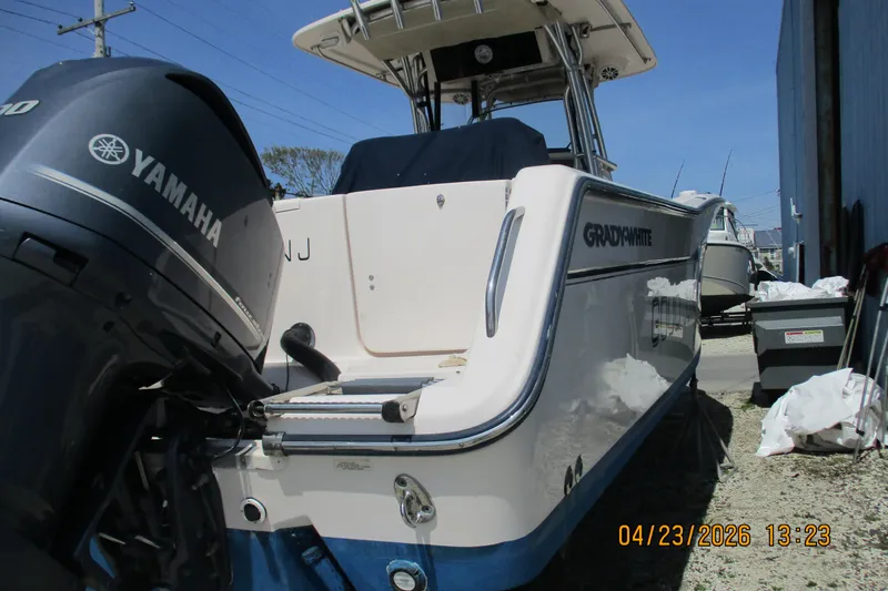 Slide: The Image of 2007 Grady-White Bimini 306 boat with Yamaha engine, docked outdoors. - 10