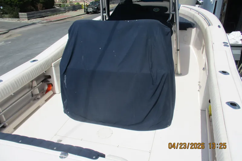 Slide: The Image of 2007 Grady-White Bimini 306 boat interior with covered console, docked outdoors. - 13