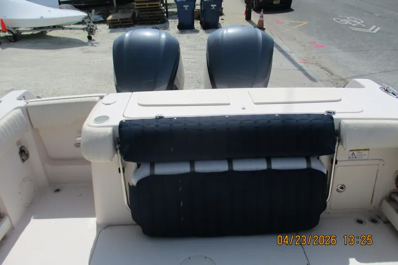 Slide: The Image of 2007 Grady-White Bimini 306 boat with dual outboard motors, docked on a sunny day. - 14