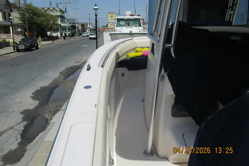 Slide: The Image of 2007 Grady-White Bimini 306 boat docked on a sunny street. - 16