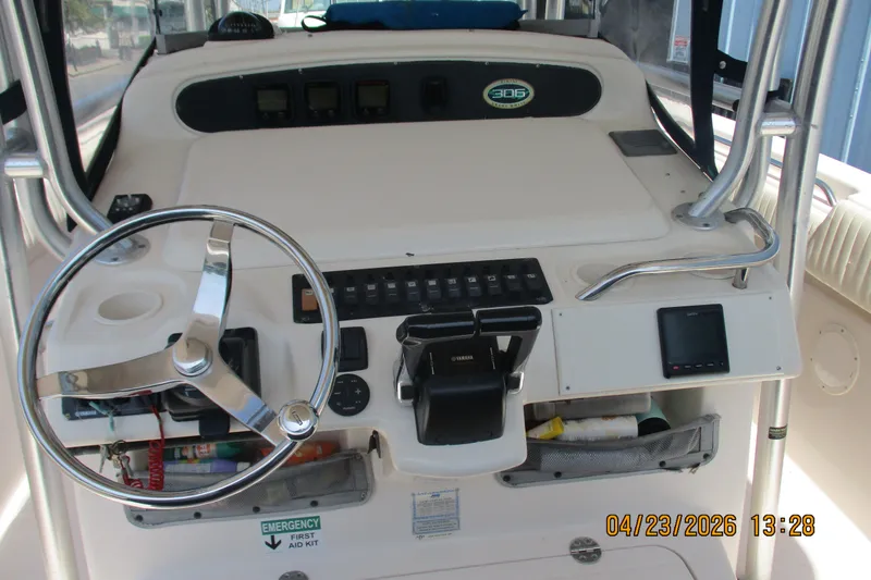 Slide: The Image of 2007 Grady-White Bimini 306 boat dashboard with steering wheel and controls. - 7