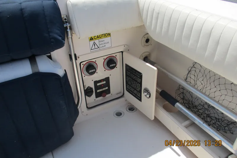 Slide: The Image of Electrical panel on 2007 Grady-White Bimini 306 boat with caution sign and seating. - 8