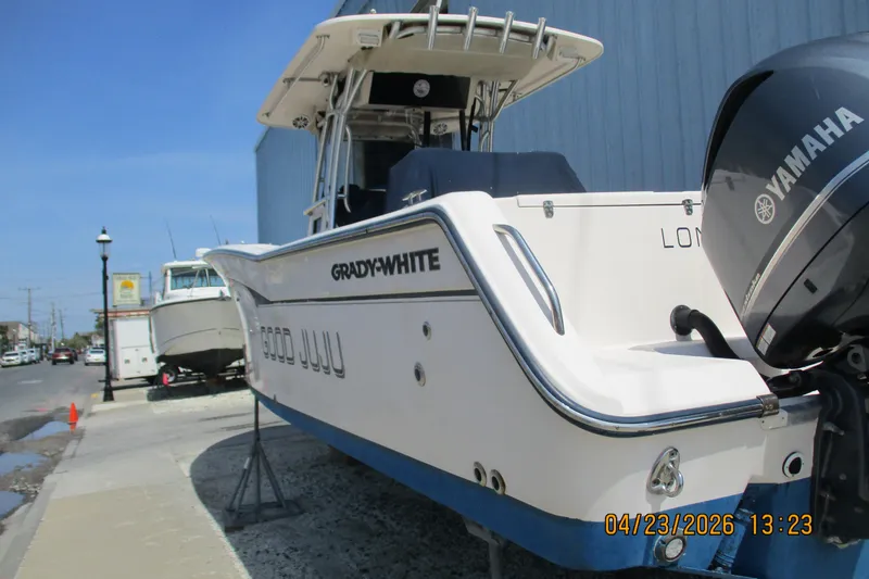 Slide: The Image of 2007 Grady-White Bimini 306 boat with Yamaha engine, docked on a sunny day. - 9