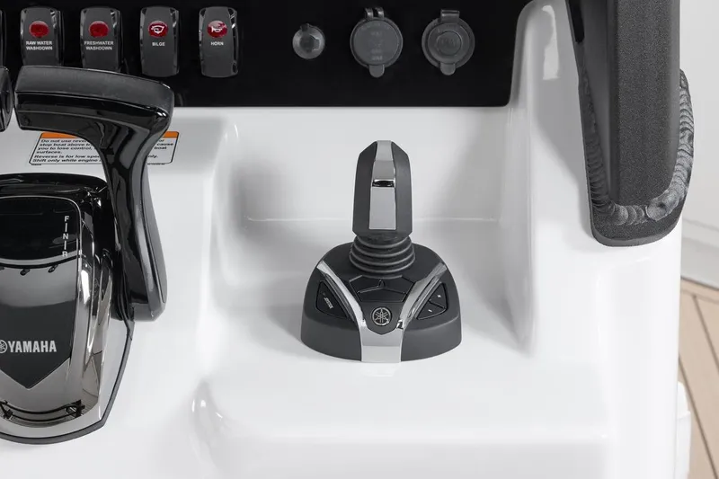 Slide: The Image of Control panel of 2026 Yamaha Boats 255 FSH Sport E with joystick and switches. - 11