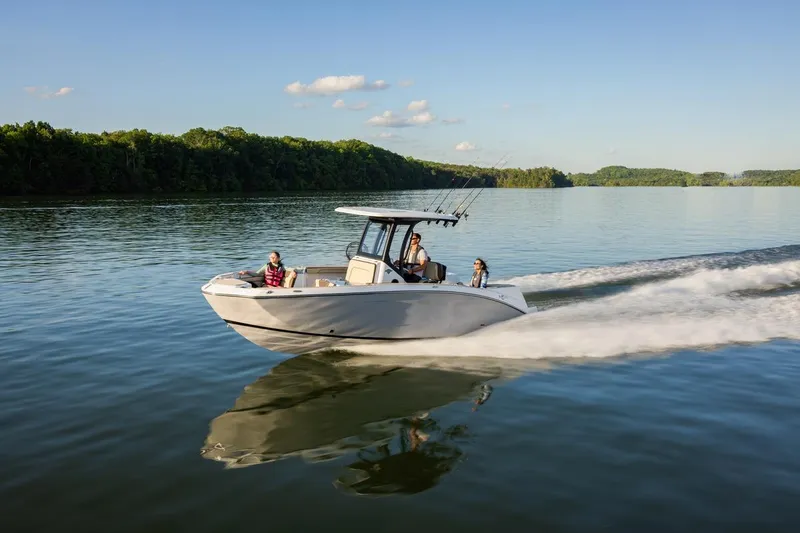 Slide: The Image of 2026 Yamaha Boats 255 FSH Sport E cruising on a serene lake. - 19