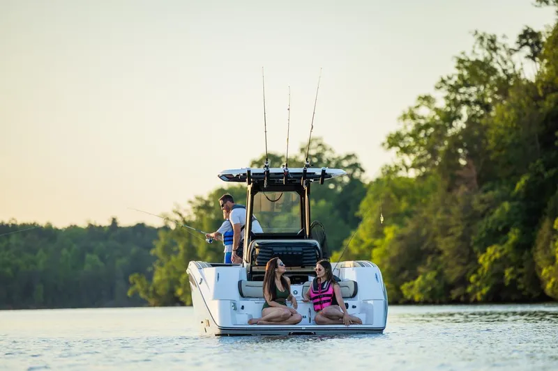 Slide: The Image of 2026 Yamaha Boats 255 FSH Sport E on a serene lake, people fishing and relaxing. - 20