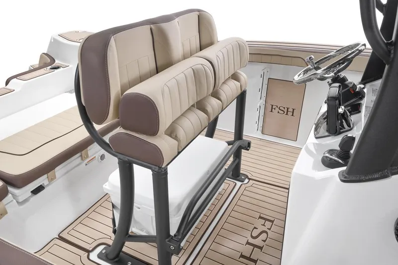 Slide: The Image of 2026 Yamaha Boats 255 FSH Sport E interior with beige seating and steering console. - 5