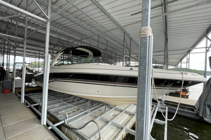 The Image of 2003 Sea Ray 290 Bow Rider docked in a covered marina. - 0