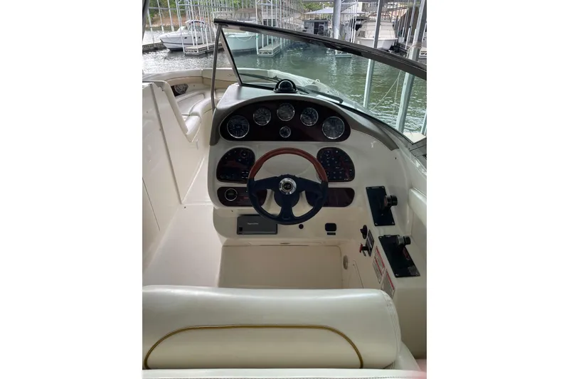 Slide: The Image of 2003 Sea Ray 290 Bow Rider helm with steering wheel and instrument panel. - 19