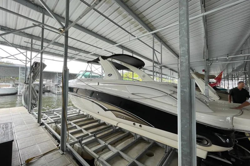 Slide: The Image of 2003 Sea Ray 290 Bow Rider docked in a covered marina. - 2