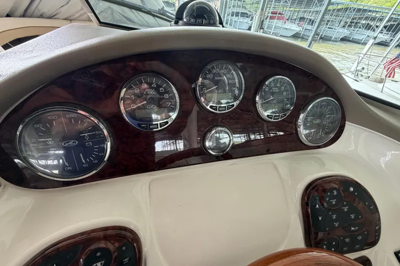 Slide: The Image of Dashboard of a 2003 Sea Ray 290 Bow Rider boat with gauges and controls. - 21