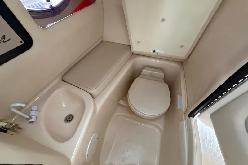 Slide: The Image of 2003 Sea Ray 290 Bow Rider bathroom with sink and toilet. - 23