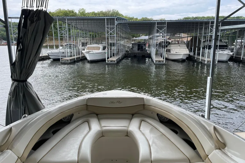 Slide: The Image of 2003 Sea Ray 290 Bow Rider docked at marina with covered slips. - 26