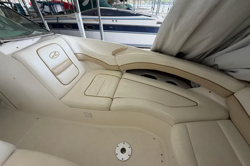 Slide: The Image of 2003 Sea Ray 290 Bow Rider interior with beige seating and elegant design. - 29