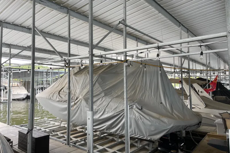 Slide: The Image of Covered 2003 Sea Ray 290 Bow Rider in marina storage, under metal roof. - 3