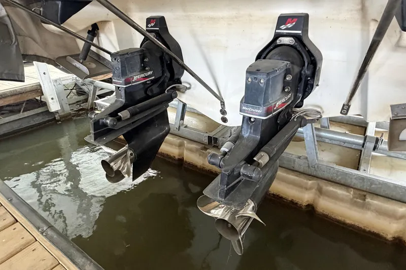 Slide: The Image of 2003 Sea Ray 290 Bow Rider with dual Mercury outboard engines in dock. - 32