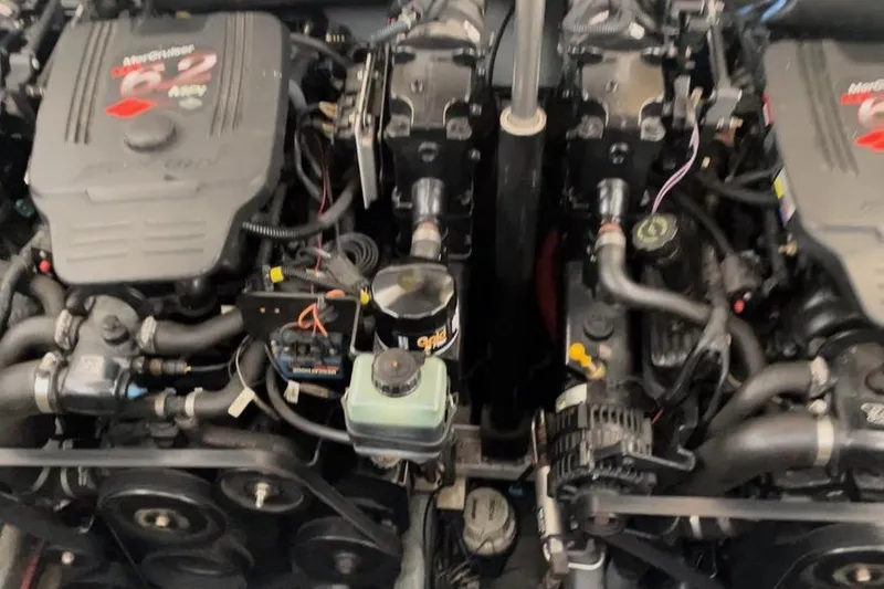 Slide: The Image of Engine compartment of a 2003 Sea Ray 290 Bow Rider boat, featuring dual MerCruiser engines. - 33