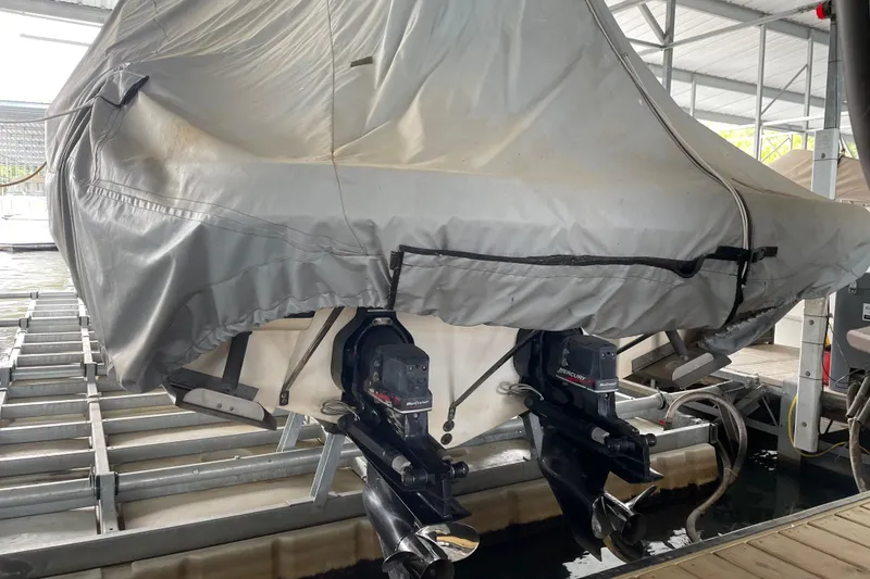 Slide: The Image of Covered 2003 Sea Ray 290 Bow Rider boat docked with dual outboard motors visible. - 4