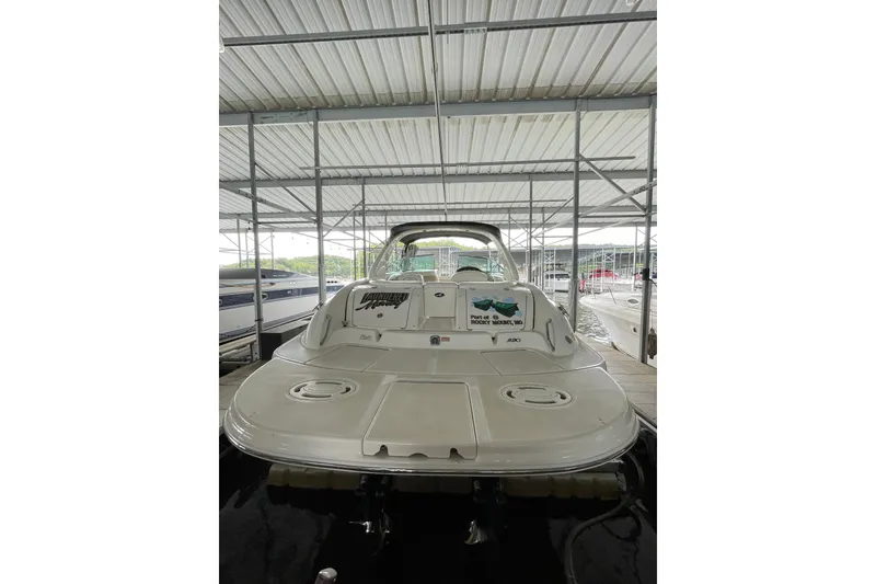Slide: The Image of 2003 Sea Ray 290 Bow Rider docked under a covered marina. - 7