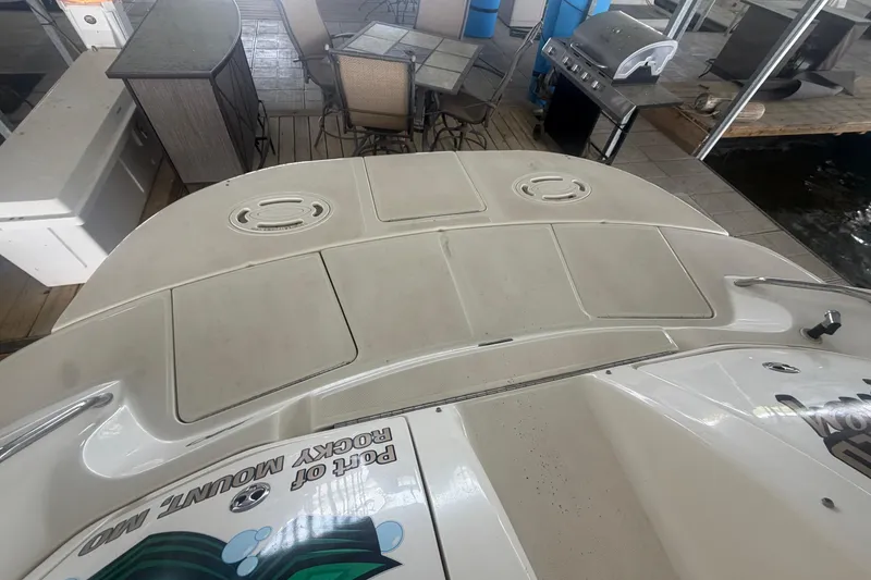 Slide: The Image of 2003 Sea Ray 290 Bow Rider boat deck with seating and grill in background. - 8