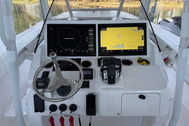 Slide: The Image of 2005 Intrepid 370 Center Console helm with dual navigation screens and steering wheel. - 15