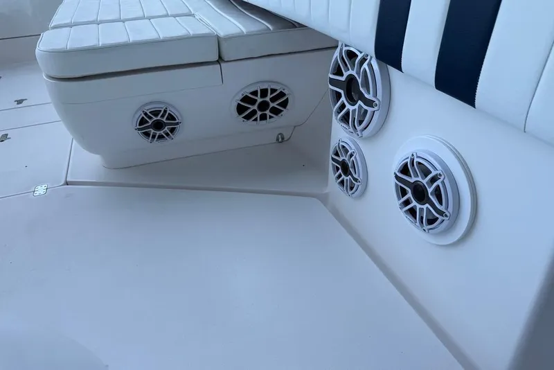 Slide: The Image of 2005 Intrepid 370 Center Console boat interior with white seating and built-in speakers. - 17