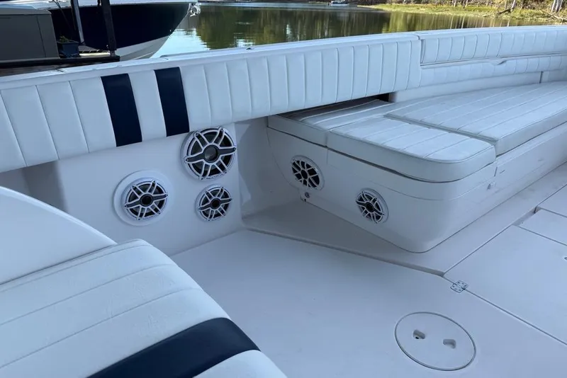 Slide: The Image of 2005 Intrepid 370 Center Console boat interior with white seating and built-in speakers. - 18