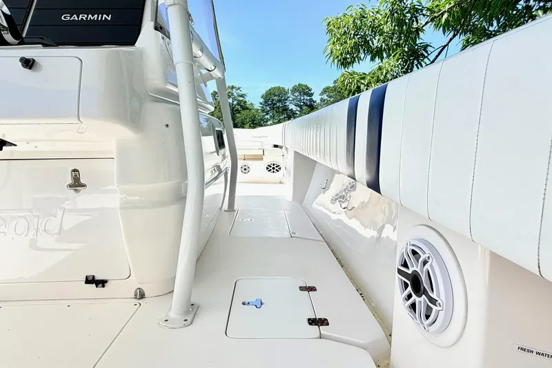 Slide: The Image of 2005 Intrepid 370 Center Console boat interior with Garmin equipment and cushioned seating. - 24