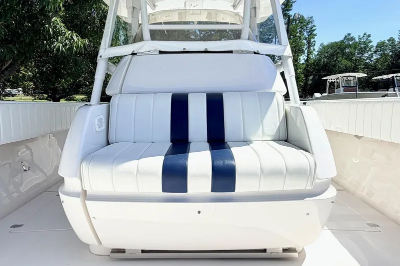 Slide: The Image of 2005 Intrepid 370 Center Console boat with white and blue seating, outdoor setting. - 26