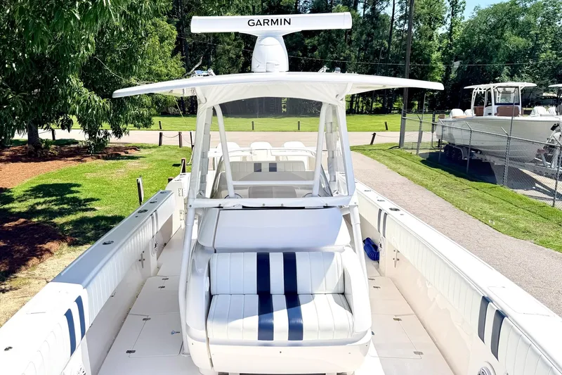 Slide: The Image of 2005 Intrepid 370 Center Console boat with Garmin equipment, docked in a sunny outdoor setting. - 27