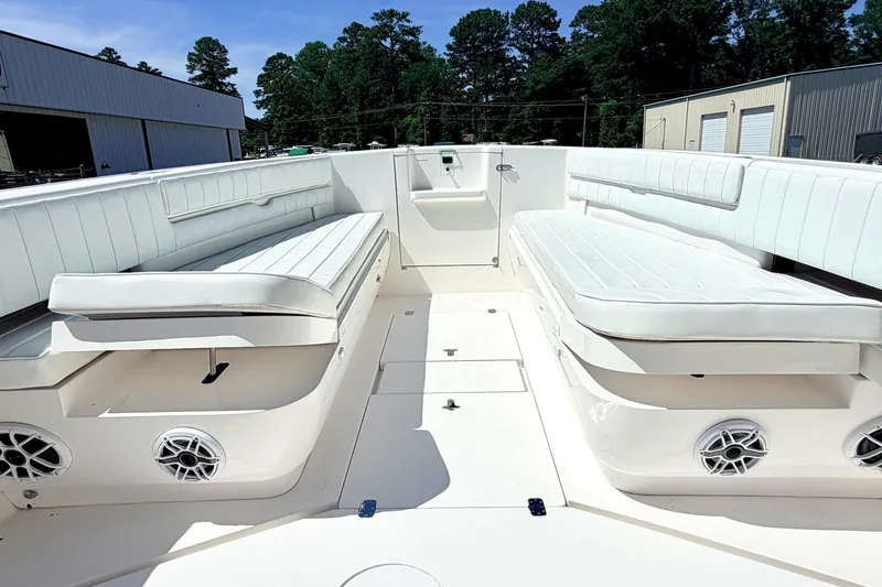 Slide: The Image of 2005 Intrepid 370 Center Console boat interior with white seating and speakers. - 29