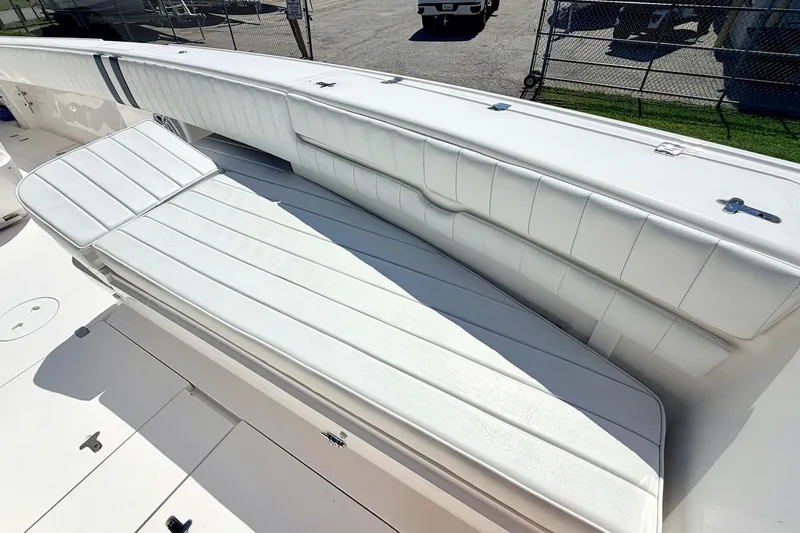 Slide: The Image of 2005 Intrepid 370 Center Console boat with white cushioned seating, docked outdoors. - 30