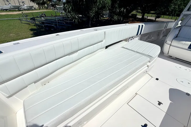 Slide: The Image of 2005 Intrepid 370 Center Console boat with white cushioned seating and spacious deck. - 32