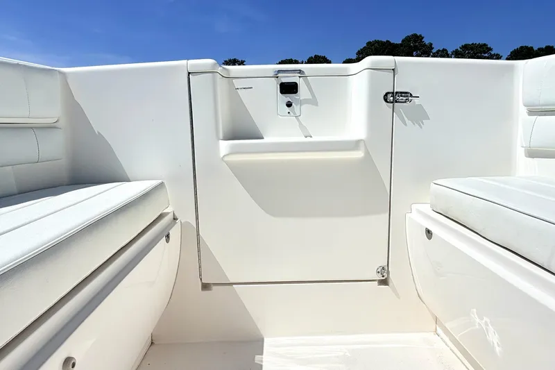 Slide: The Image of 2005 Intrepid 370 Center Console boat interior with white seating and storage compartments. - 34