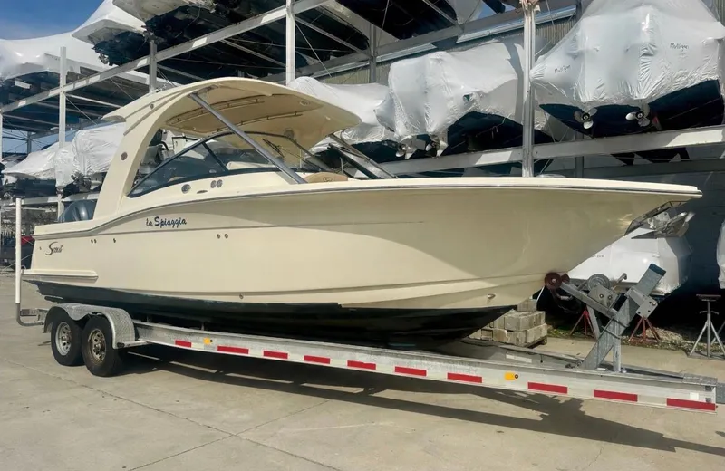 The Image of 2015 Scout 275 Dorado boat on trailer in outdoor storage. - 0