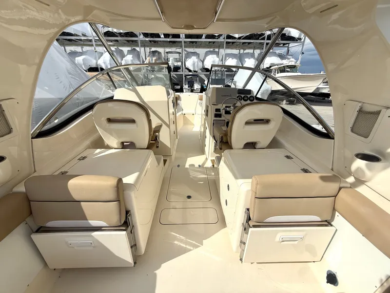 Slide: The Image of Interior of a 2015 Scout 275 Dorado boat with beige seating. - 10
