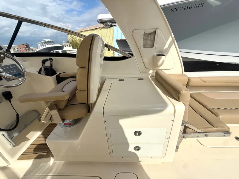 Slide: The Image of Interior of a 2015 Scout 275 Dorado boat with beige seating. - 13