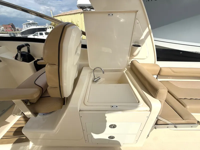 Slide: The Image of Interior of a 2015 Scout 275 Dorado with seating and sink. - 14