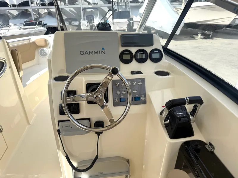 Slide: The Image of Helm console of a 2015 Scout 275 Dorado boat with Garmin system. - 16